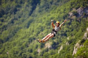 A woman ziplining, one of the most popular thrill-seeking activities